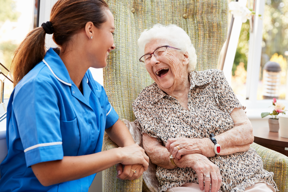 Nurse speaking with senior in a retirement home.