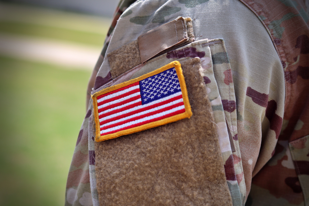 U.S. Army soldier with an American flag patch on their arm.