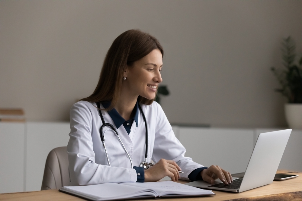 Female doctor conferencing on a laptop.