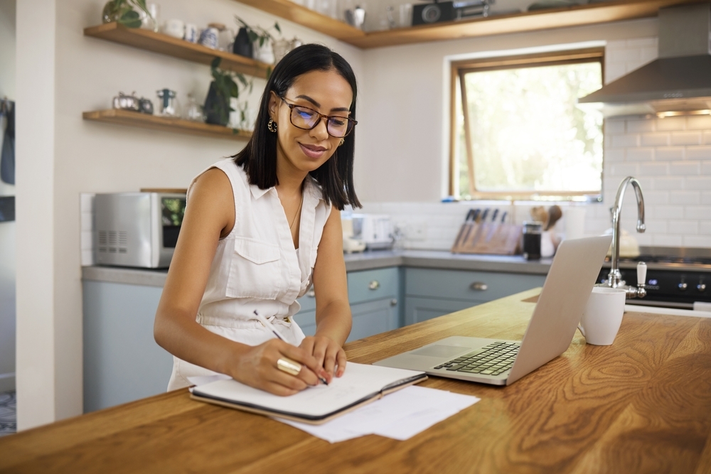 Young woman standing up while working from home.