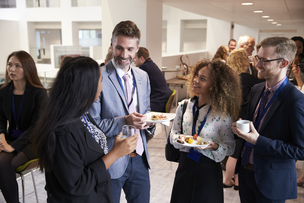 Delegates networking during conference lunch break.