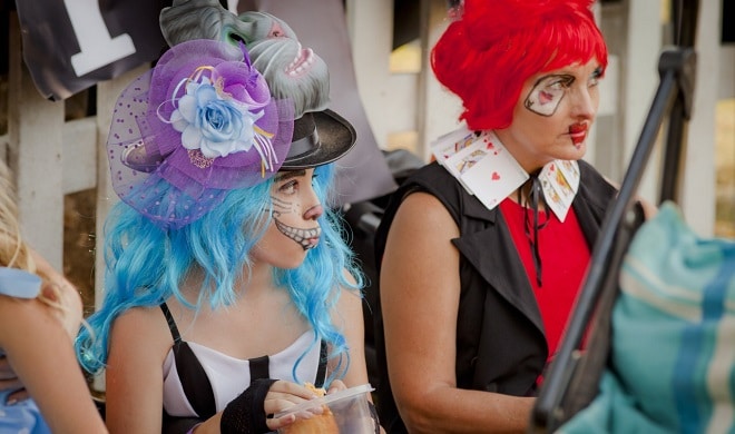 People dressed up in costumes for a Mad Hatter's Tea Party