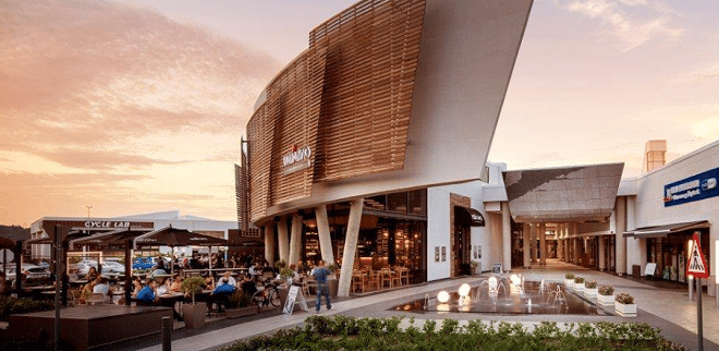 the outside of lynnridge mall with a sunset in the background