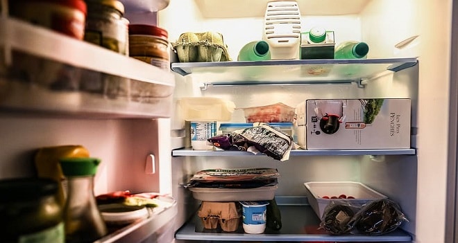 clean fridge door open with food inside