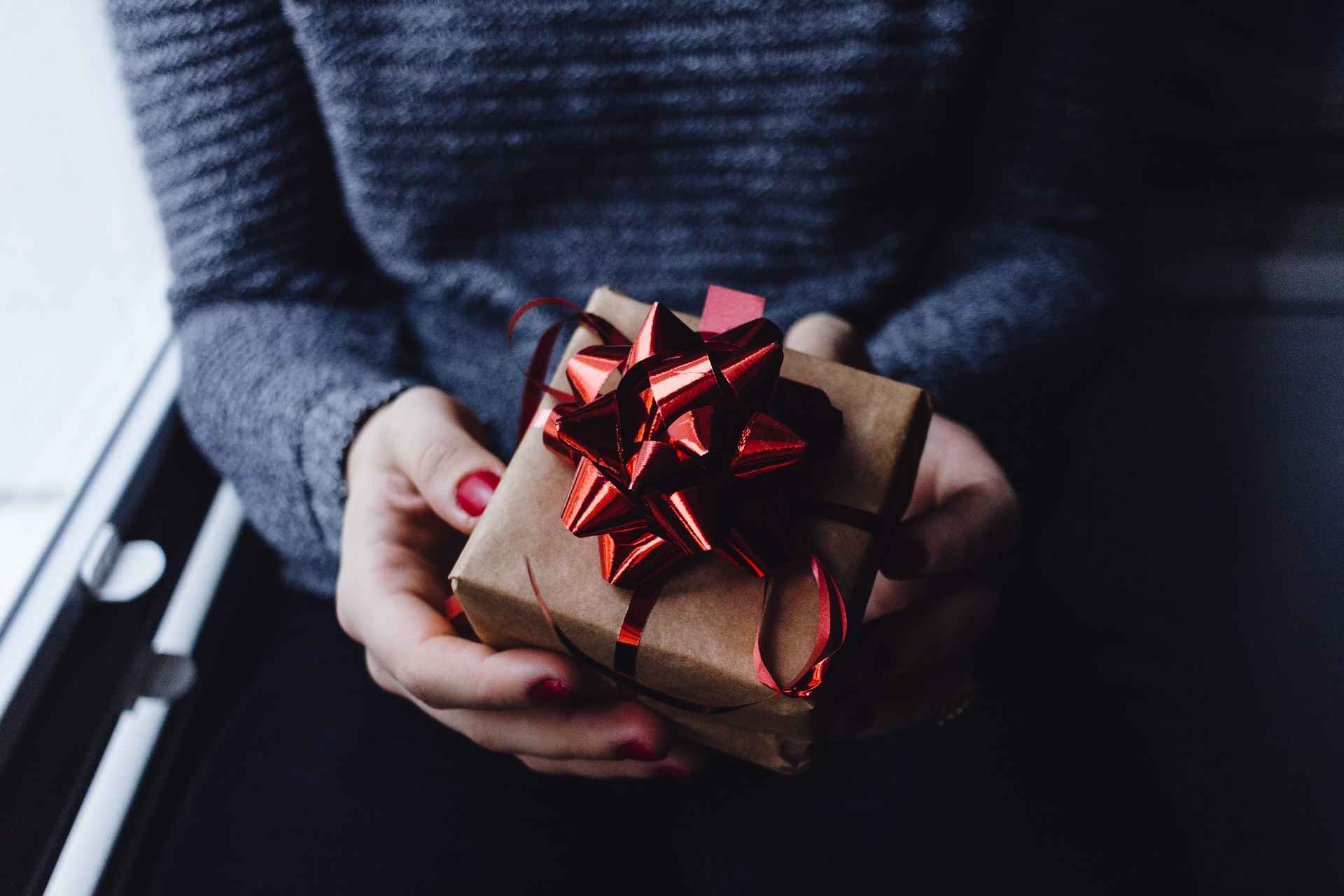 Woman holding a wrapped employee appreciation gift