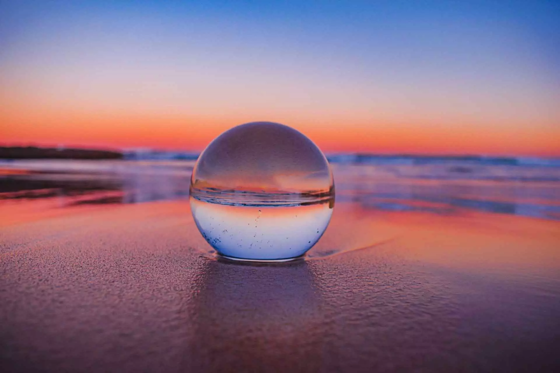 A crystal ball lying in the sand as a representation to predict hiring trends