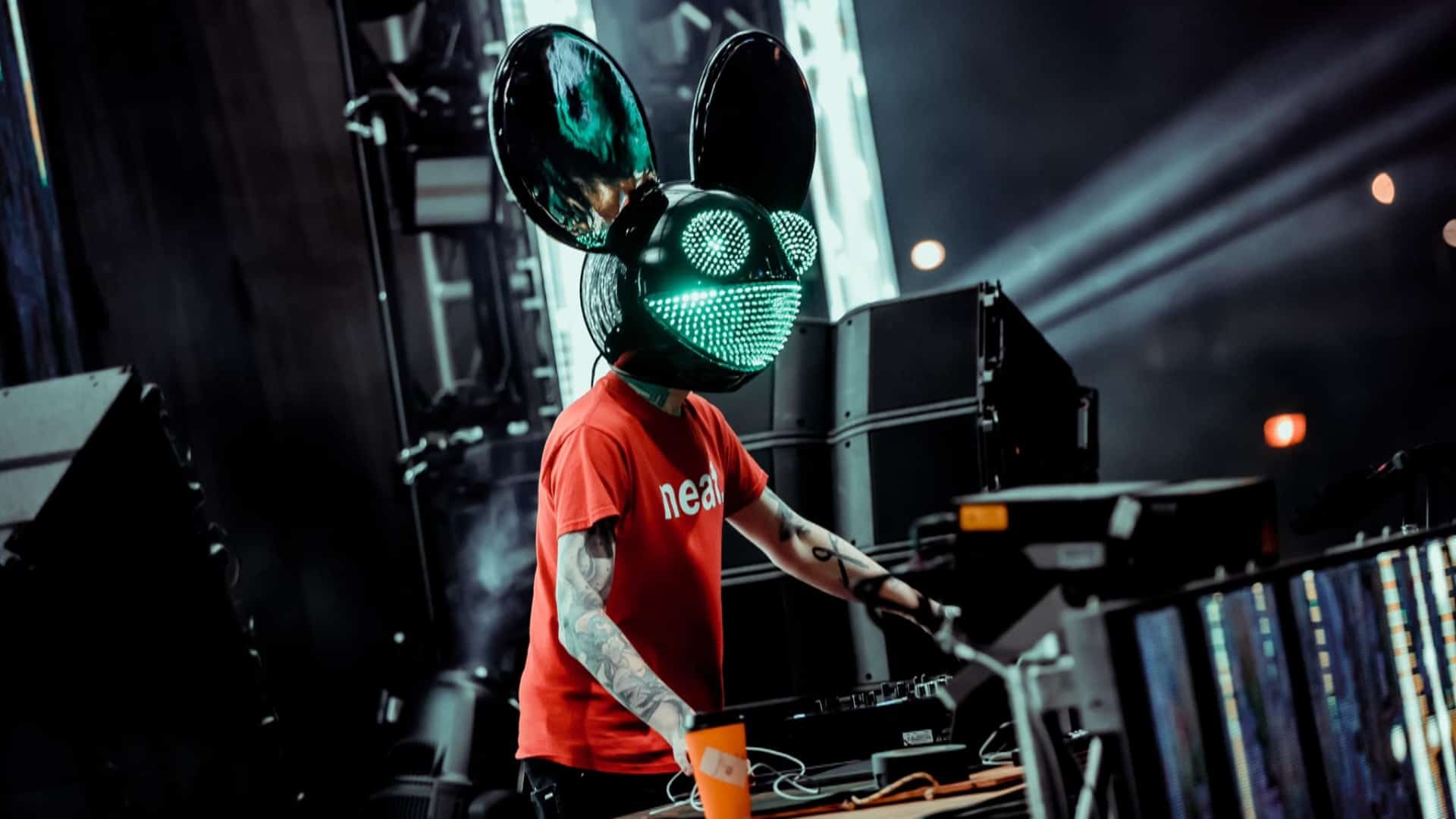 A DJ performing wearing an electronic mouse head