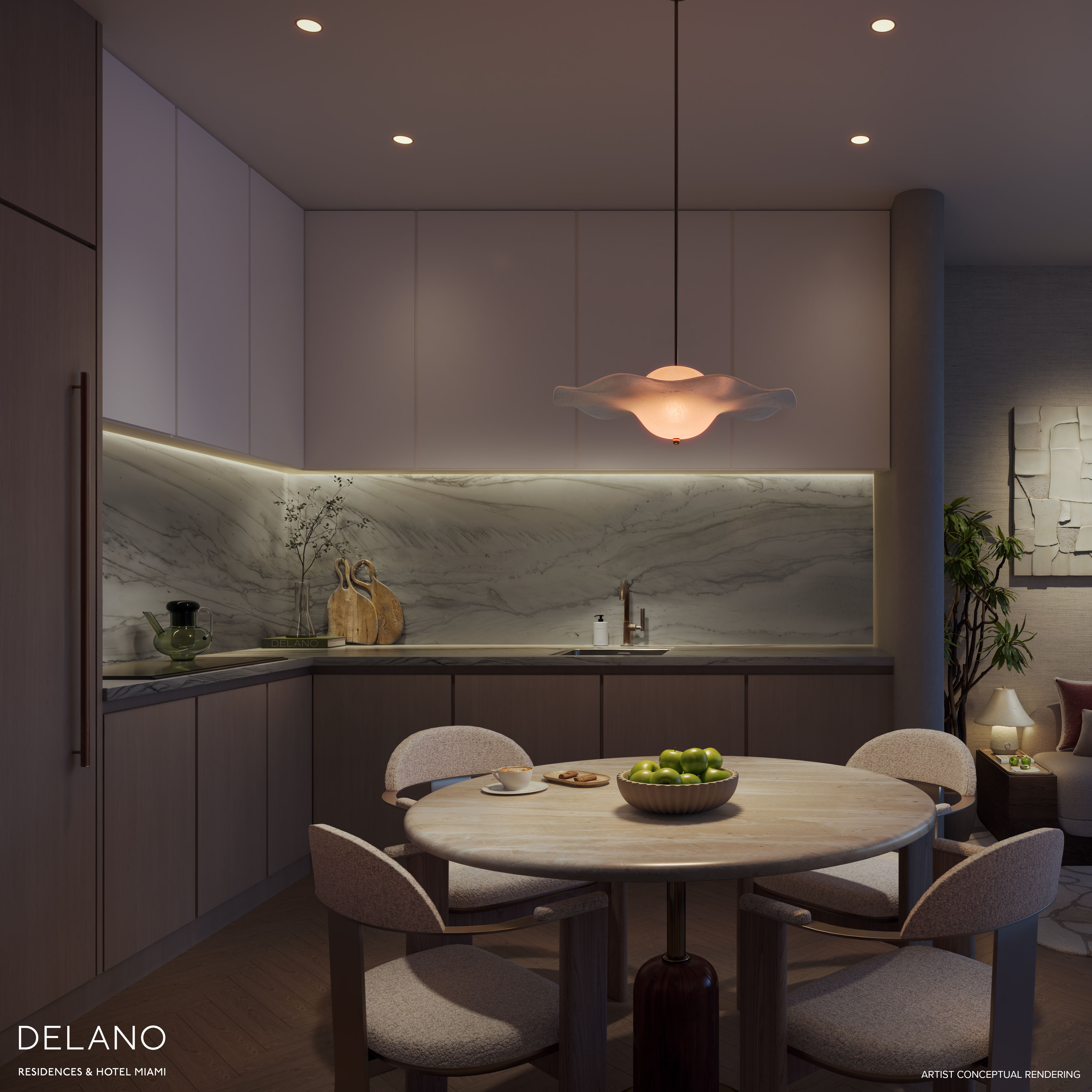 Residence kitchen with a veined marble backsplash and pale oak cabinetry by Meyer Davis