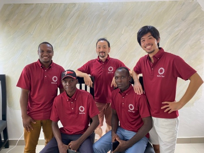 CEO Carlos Oba (center) and COO Sho Nakata (right) with staff from Benin. &nbsp; &nbsp; Source: Dots for