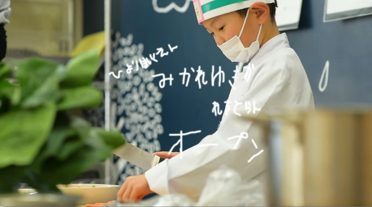 Nursery school children prepare food with real knives