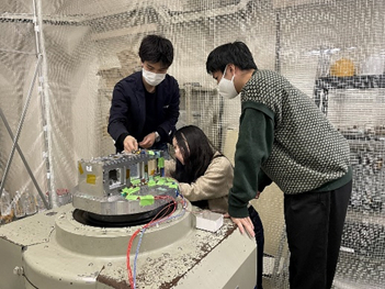 The Kyoto University team conducts a vibration experiment on a wooden satellite. &nbsp; &nbsp; Source: Kyoto University