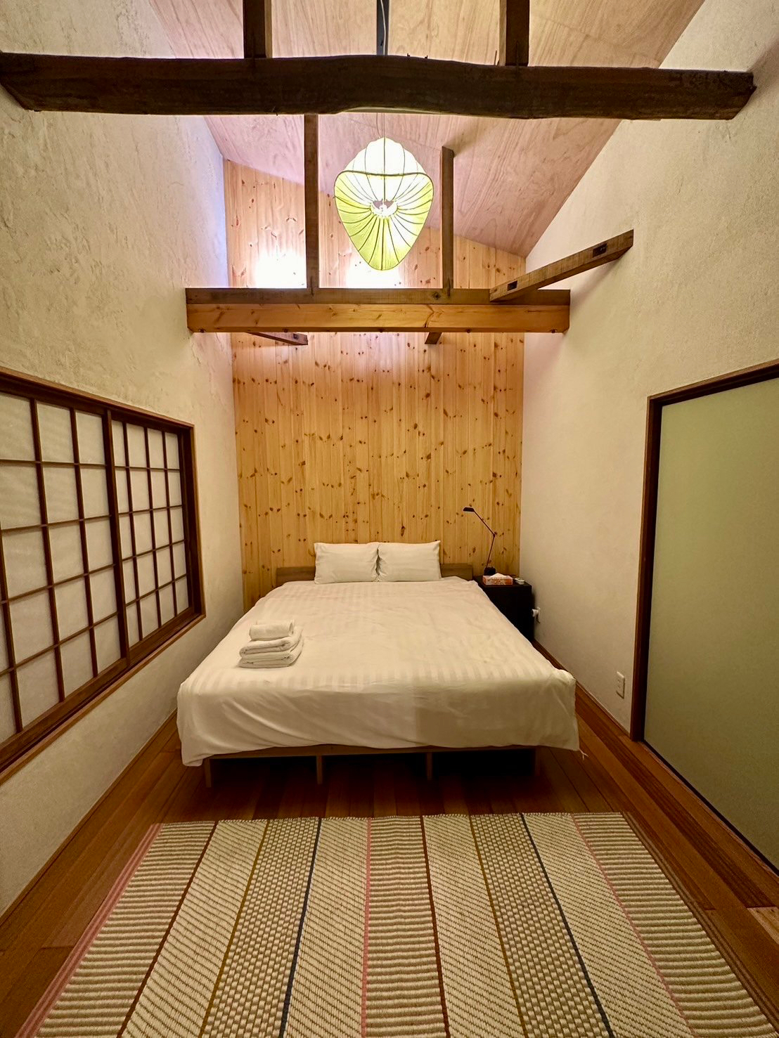 The ceiling was removed to make the second-floor bedroom feel more spacious.