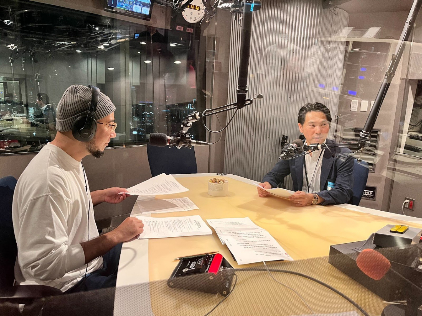 Grover (left), host of the radio program Jam the Planet on J-WAVE (81.3FM), alongside the author (right), appearing as a news commentator in his capacity as JStories executive editor. Photo by JStories