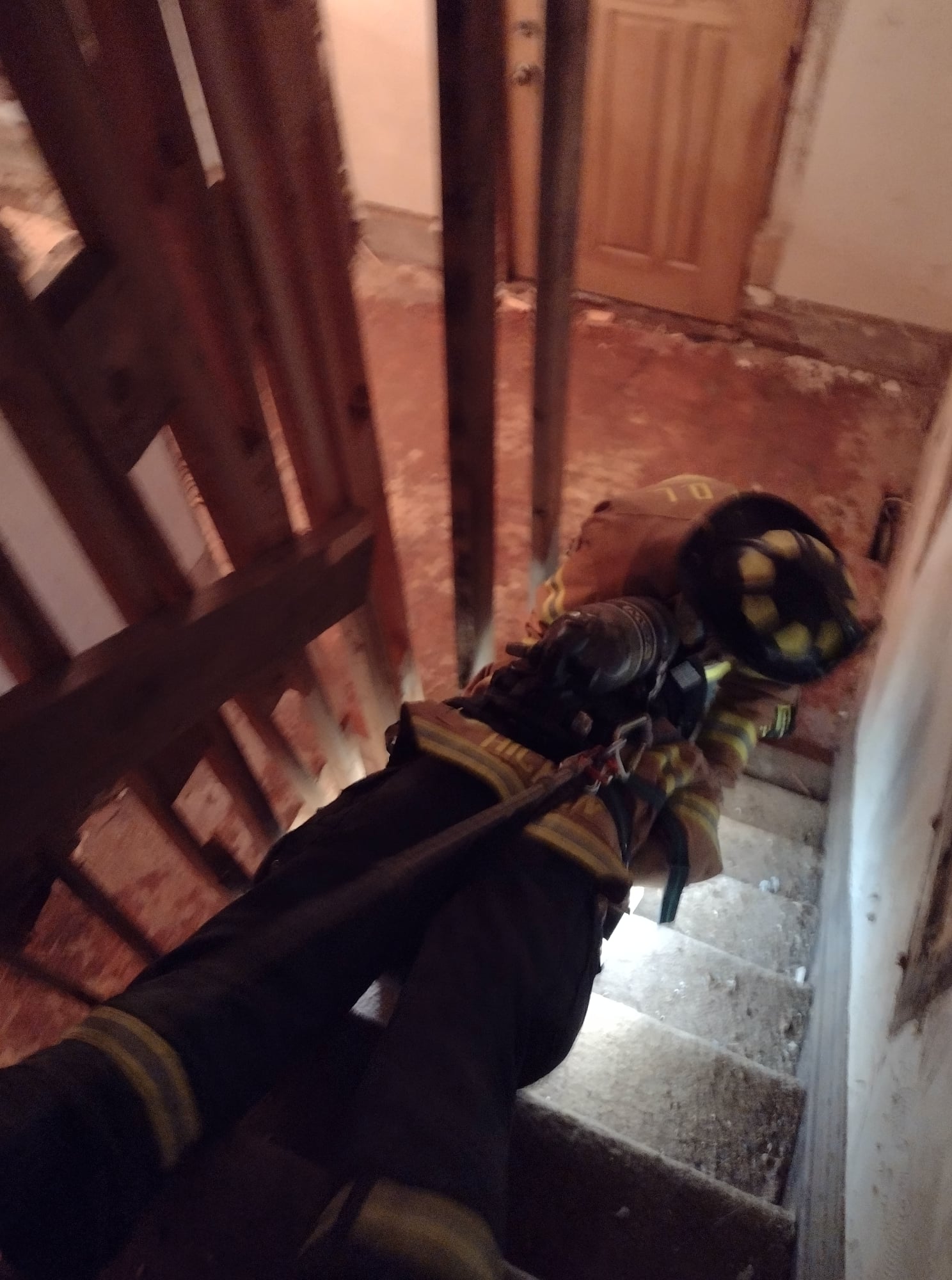 Dragging firefighter down stairwell during training