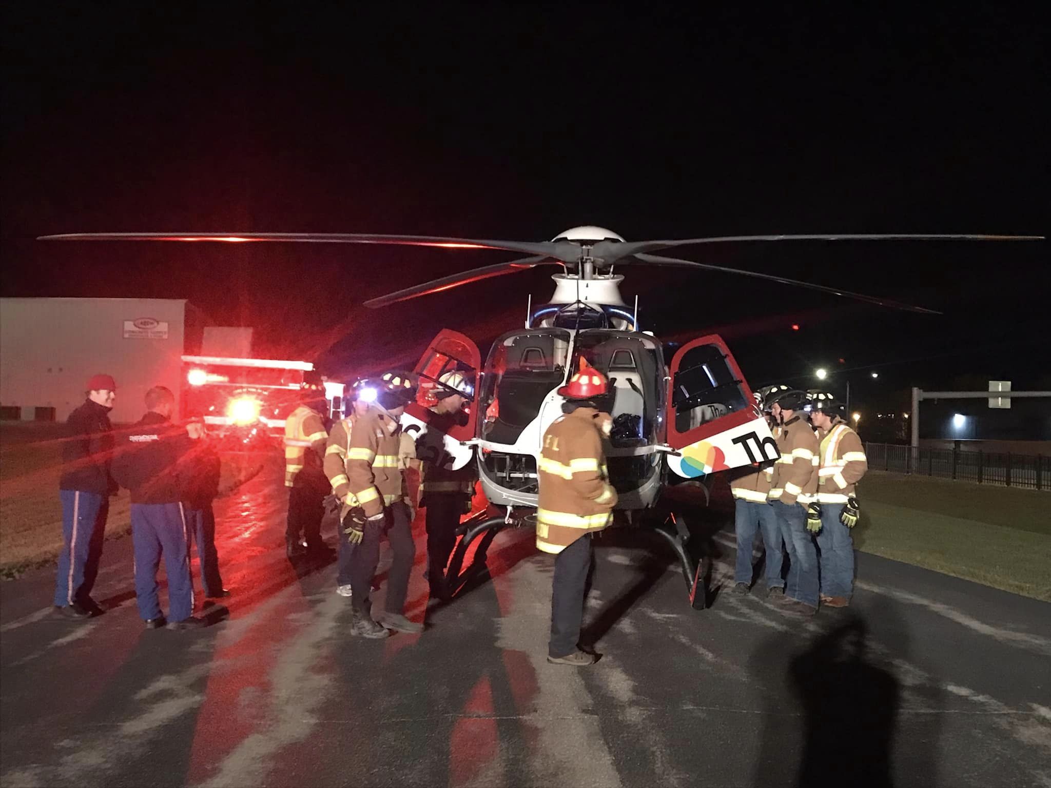 Firefighters assisting medical air crew