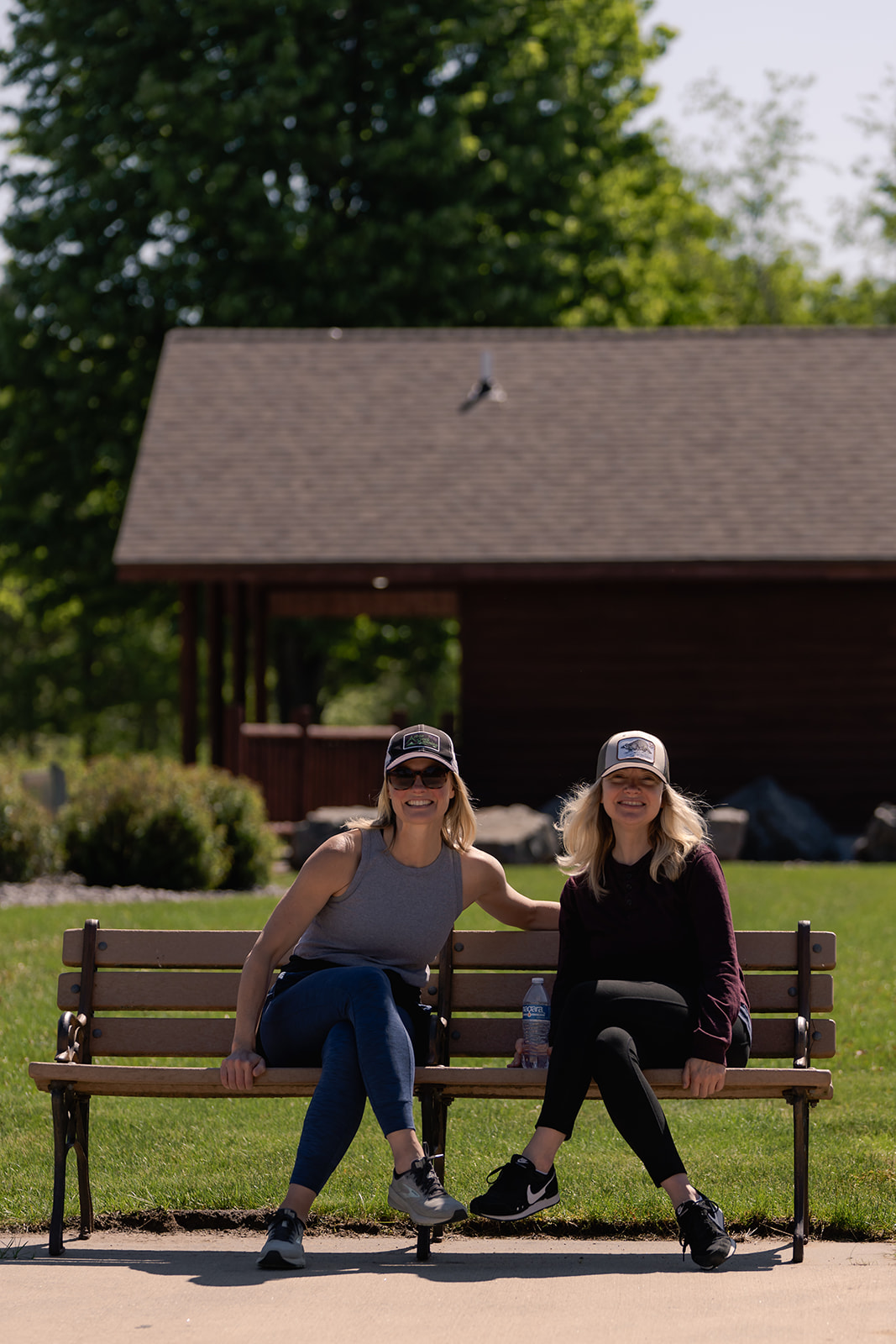 Two women sitting on a park bench