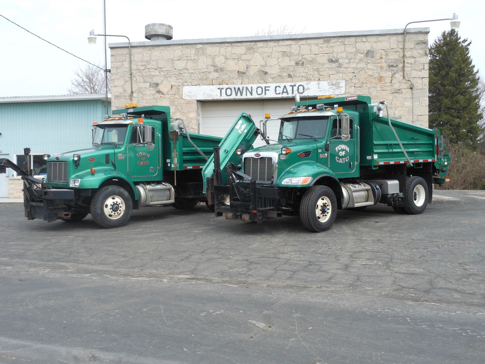 Two green dump trucks owned by Cato town