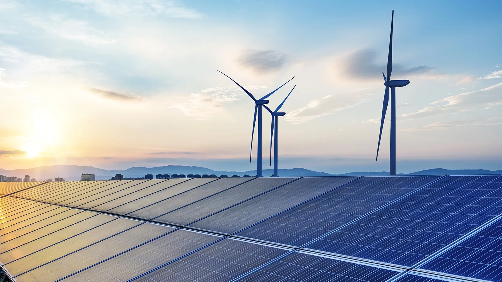 Solar panels and wind turbines under a blue sky.