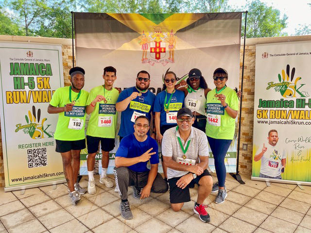 BOLD-employee-resource-group-members-in-front-of-jamaica-4k-run-signage