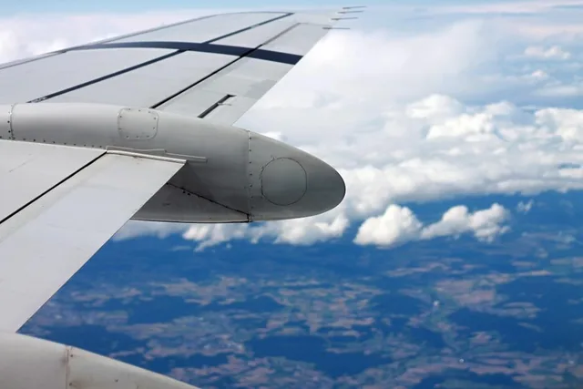An aircraft wing above a layer of cloud