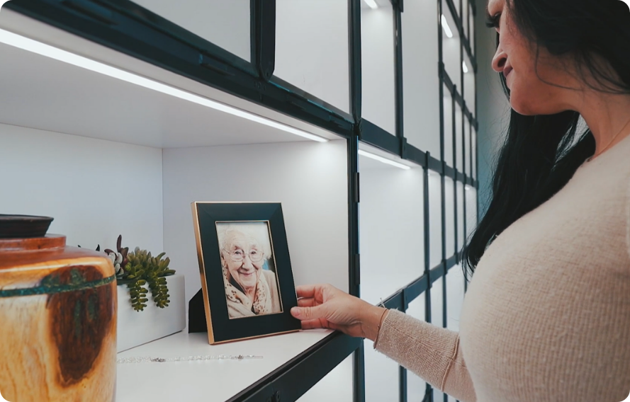 Framed memorial photograph and keepsakes on a shelf