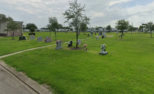 Open memorial lawn with monuments at Memory Gardens Cemetery