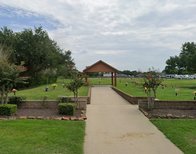 A quiet walkway leading to a garden pavilion at Memory Gardens Cemetery