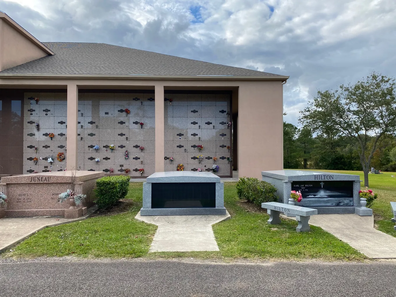 Pink granite mausoleum crypts beside the columbarium building at Oak Bluff Memorial Park