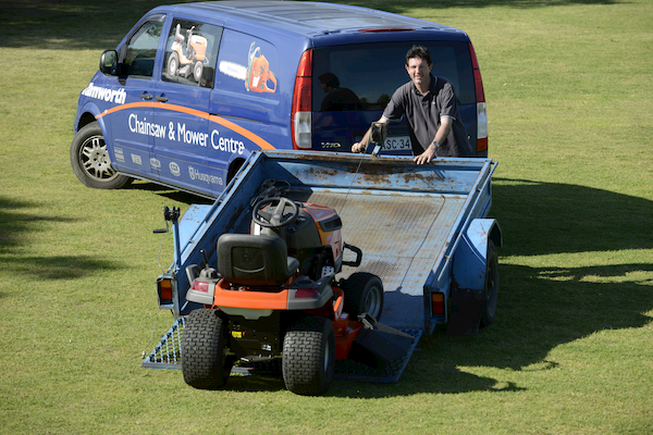 Mower being loaded onto trailer