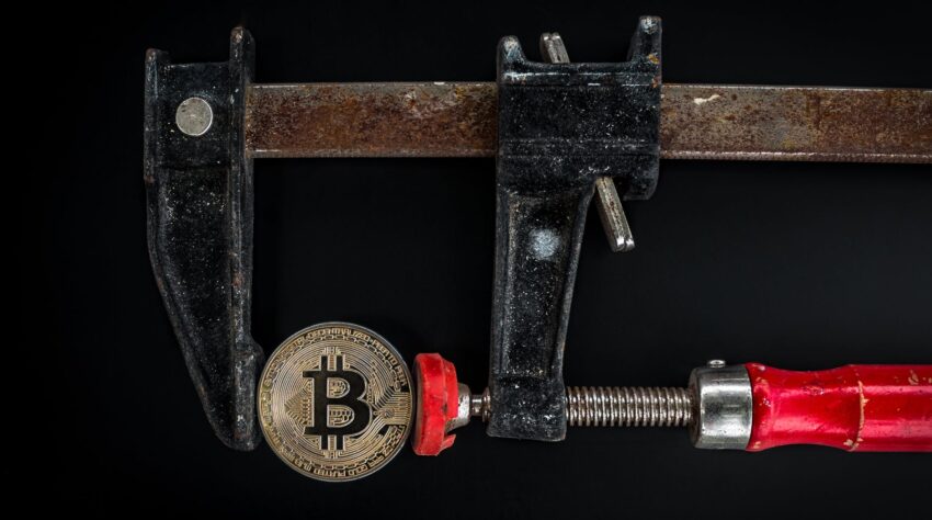 black and red caliper on gold colored bitcoin