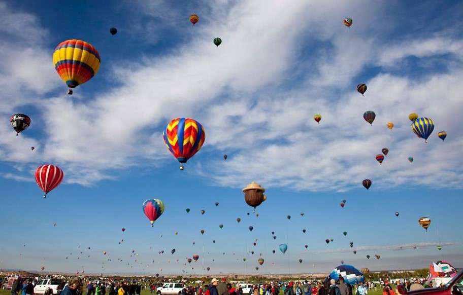 Hot-air balloons floating above a travel landscape