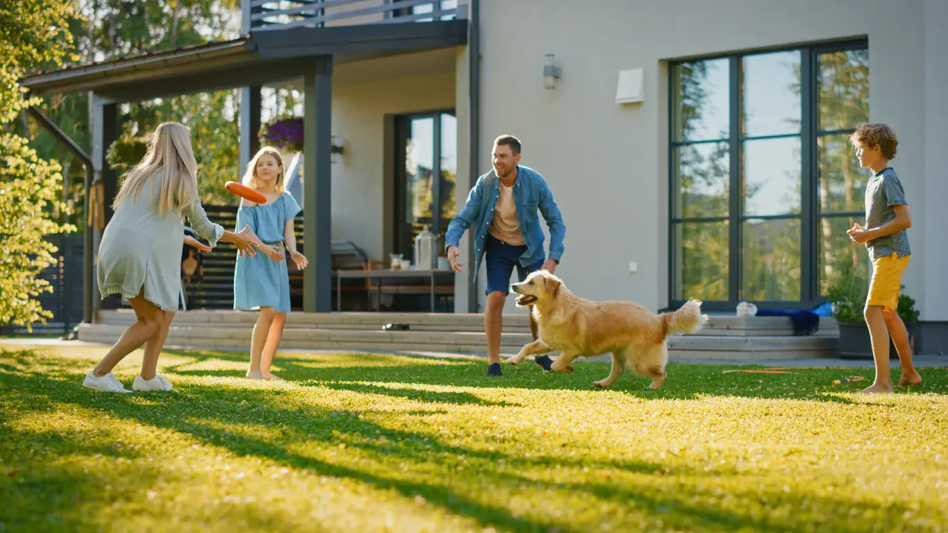 Family with dog enjoying their healthy, safe lawn