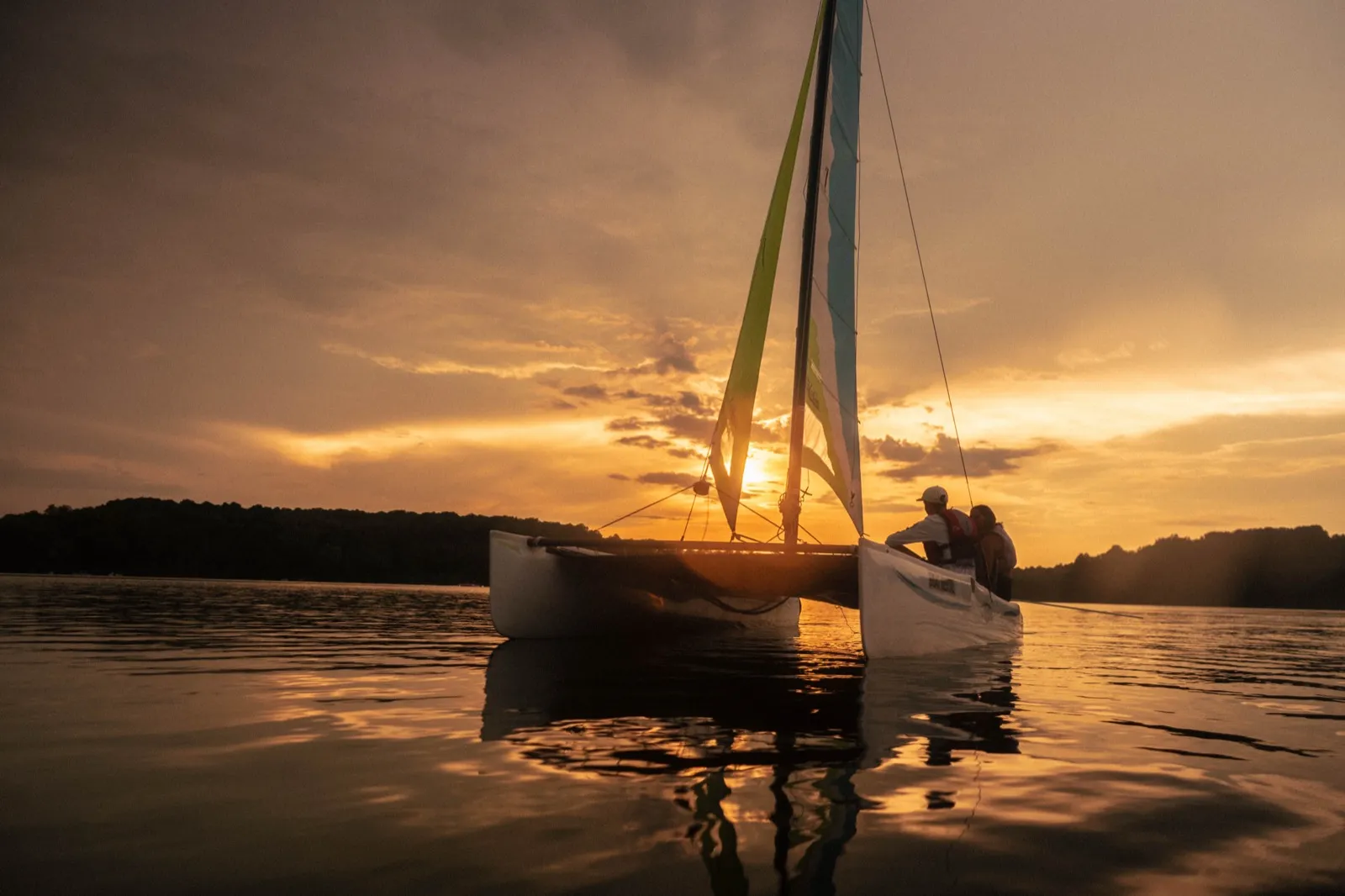Hobie catamaran silhouetted against a glowing sunset on Marsh Creek Lake