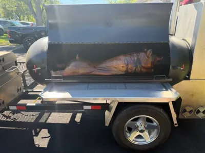 Whole pig in the trailer roaster, cooked on site