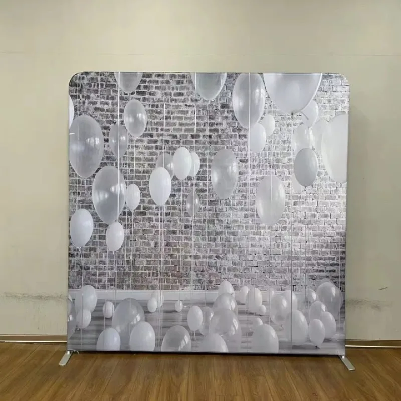 White balloons against brick wall backdrop