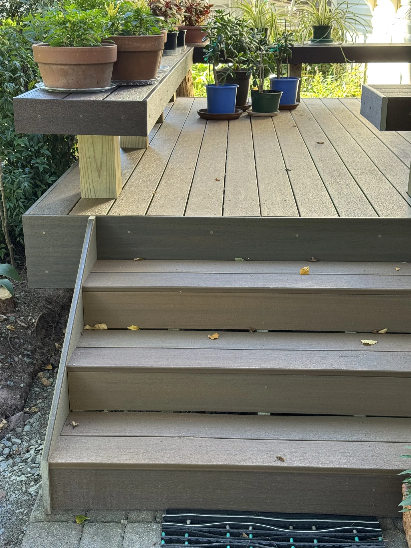 Finished composite deck steps with planters