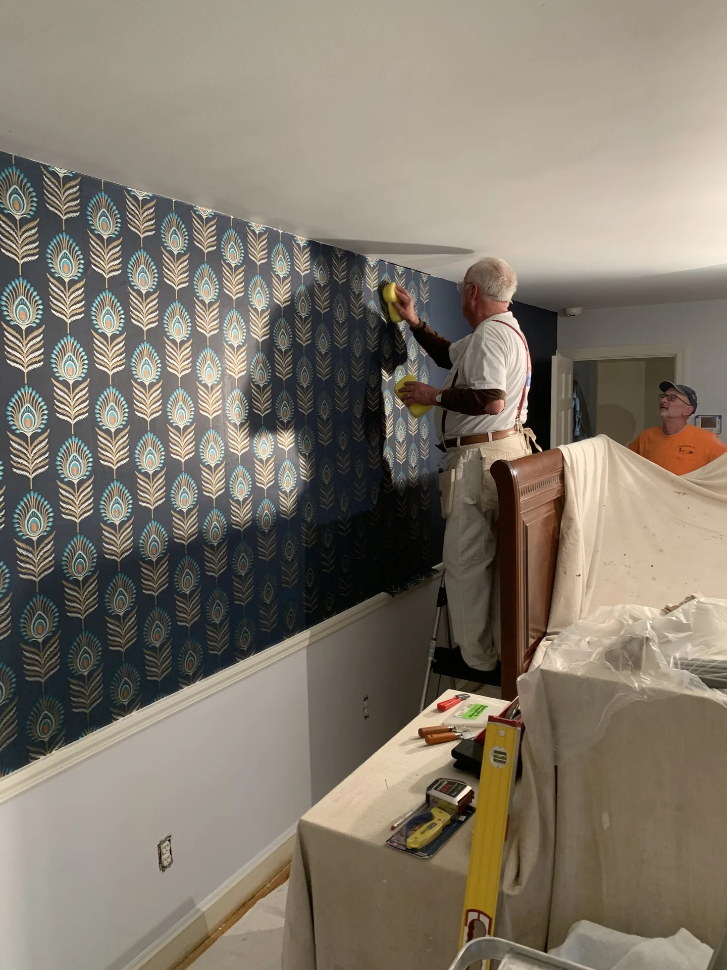 Peacock wallpaper accent wall installation
