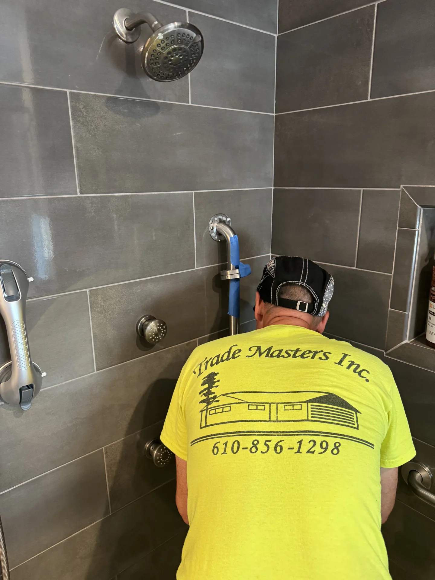Accessibility grab bar installation in tiled shower