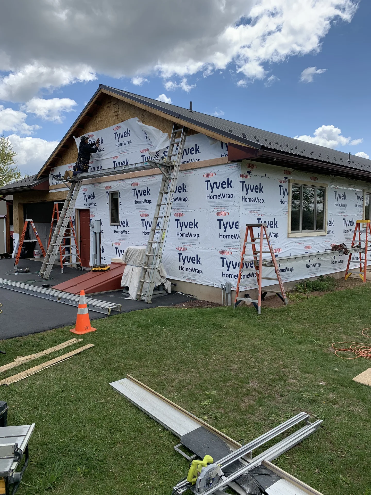 Siding crew at work on wrapped home