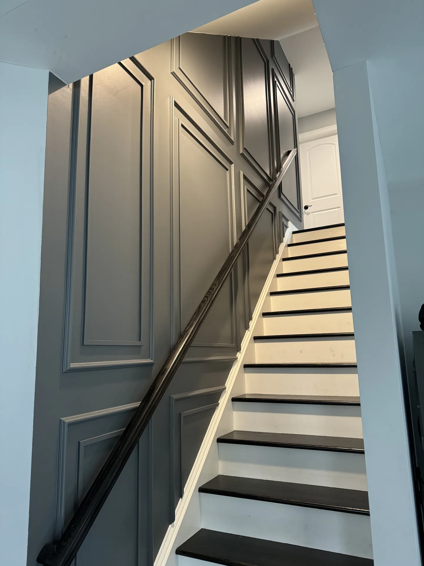 Gray panel wainscoting staircase