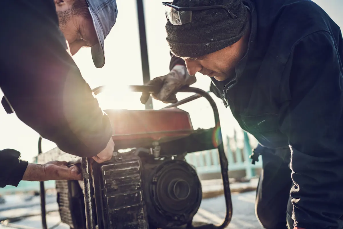 Technicians servicing a portable generator
