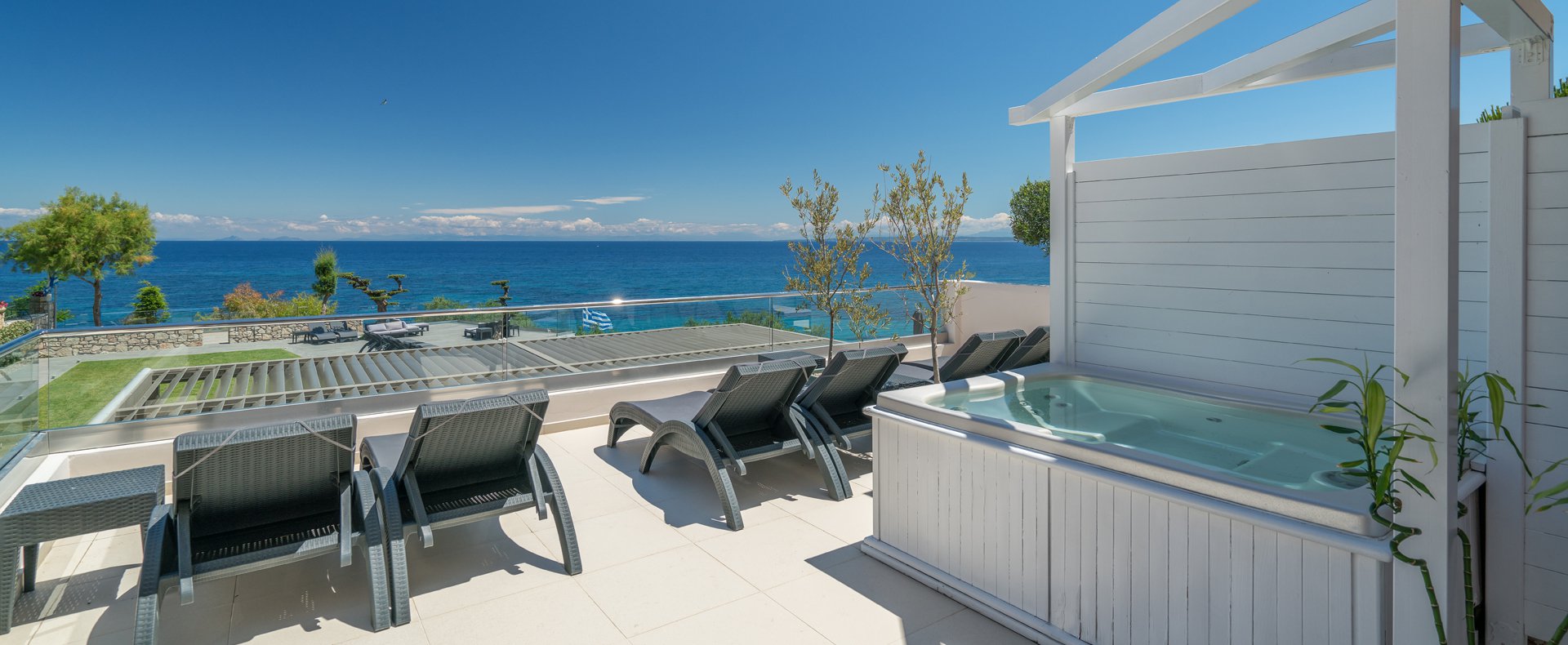 Veranda with sunbeds facing the Ionian Sea at Kymothoe Elite Suites in Zakynthos