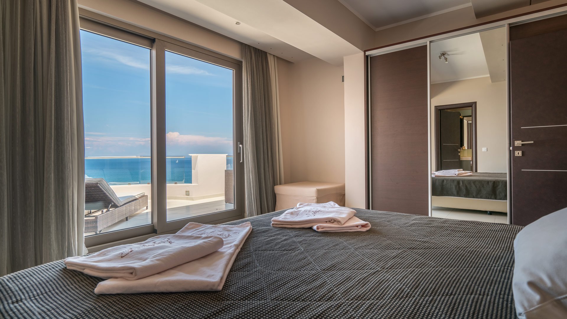 The bedroom and its view of the Ionian Sea that Kymothoe Elite Suites offers in Zakynthos