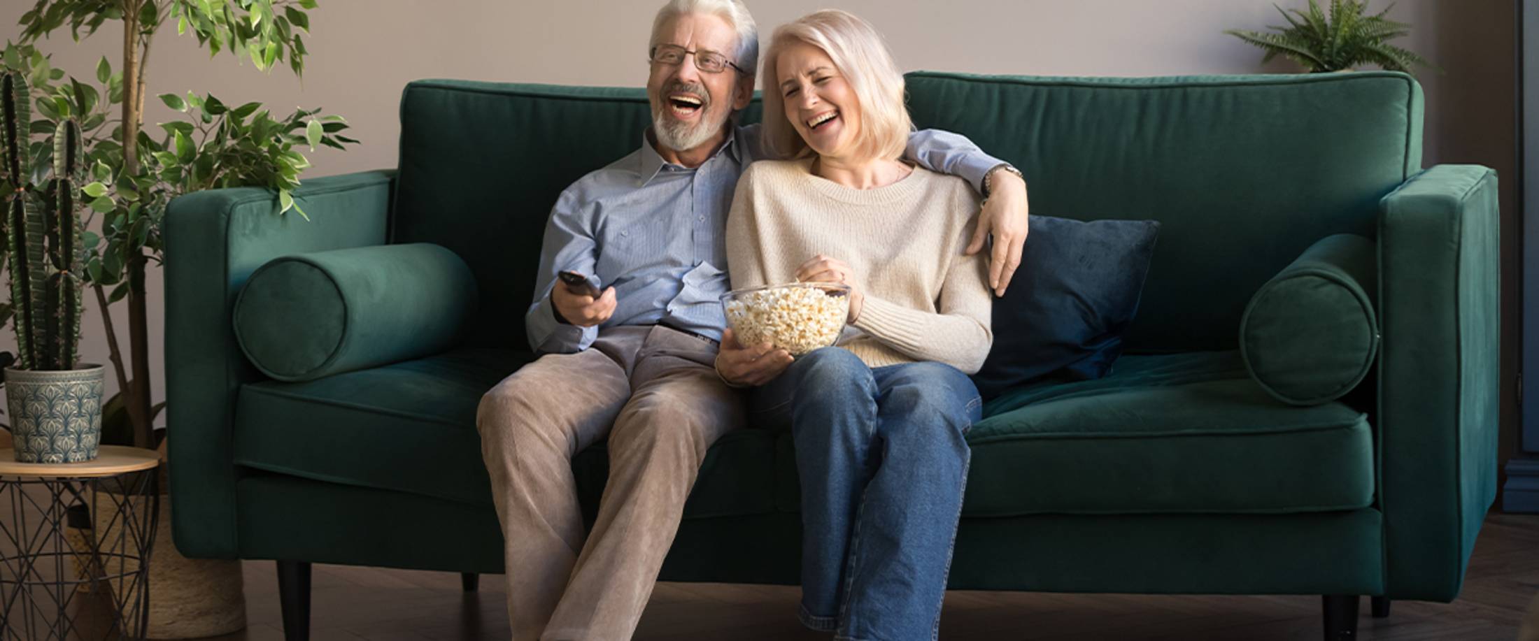 senior couple enjoying a movie marathon in their senior apartment senior couple enjoying a movie marathon in their senior apartment