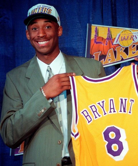 Kobe Bryant holding his number 8 jersey