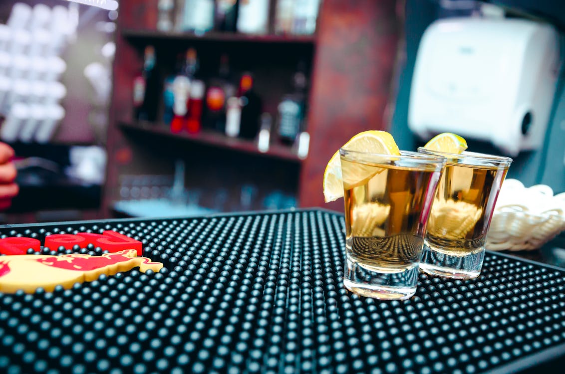 Free Two Clear Shot Glasses Filled With Alcohol Stock Photo