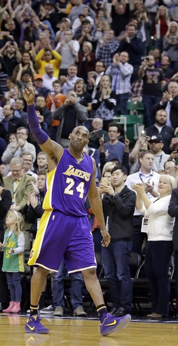 Kobe Bryant on the court waving to fans.