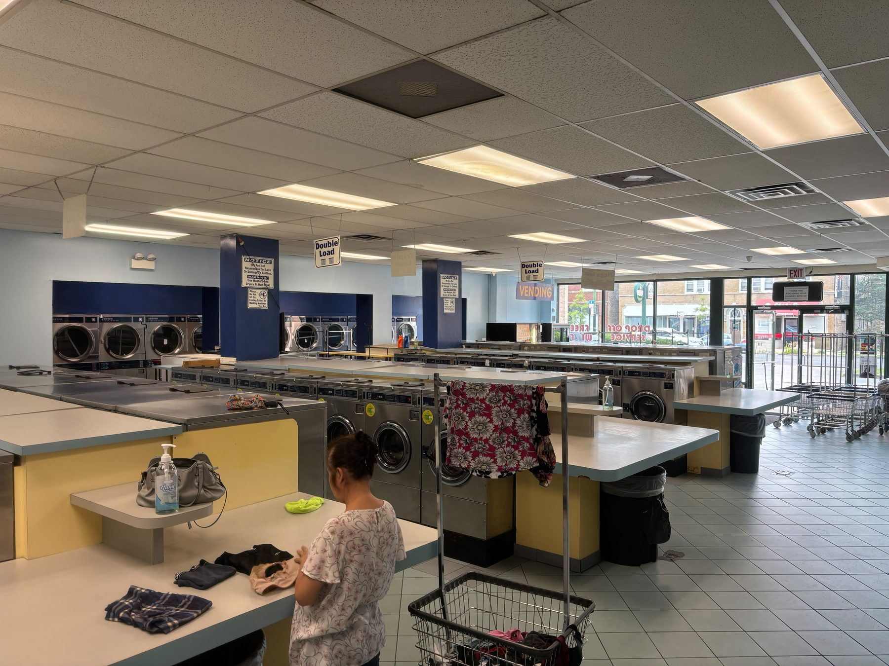 Laundry Station's self-service machine floor with rows of washers and dryers