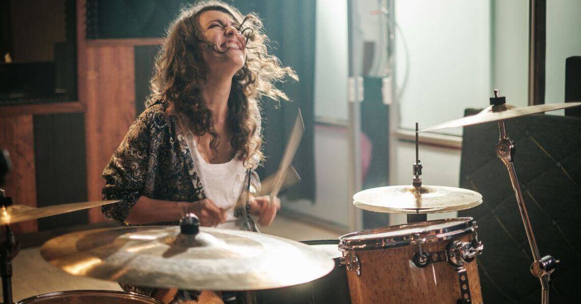 Young woman playing drums