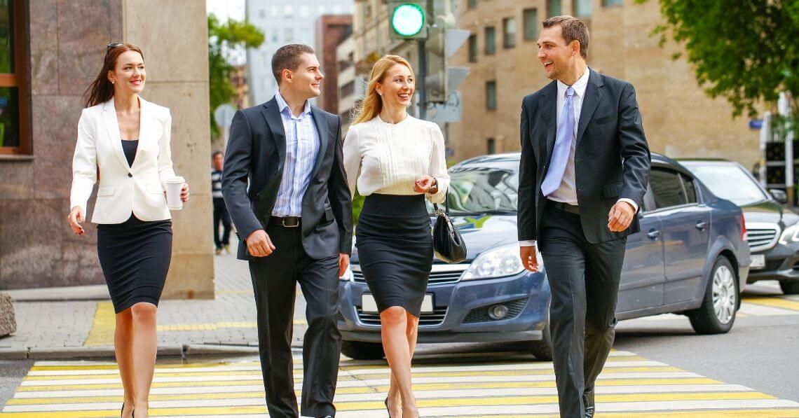 A group of business people crossing the street